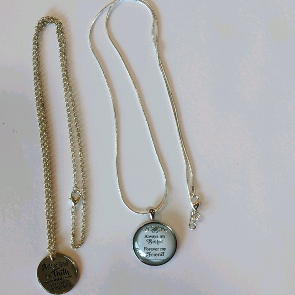 Two pendent silver necklaces with sayings